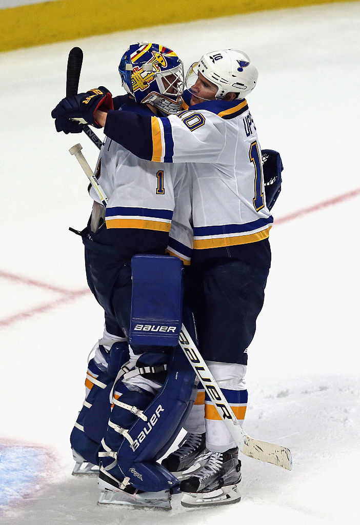 CHICAGO, IL - APRIL 17: Brian Elliott #1 of the St. Louis Blues (L) gets a hug from teammate Scottie Upshall after a win against the Chicago Blackhawks  in Game Three of the Western Conference Quarterfinals during the 2016 NHL Stanley Cup Playoffs at the United Center on April 5, 2016 in Chicago, Illinois. The Blues defeated the Blackhawks 3-2. (Photo by Jonathan Daniel/Getty Images)