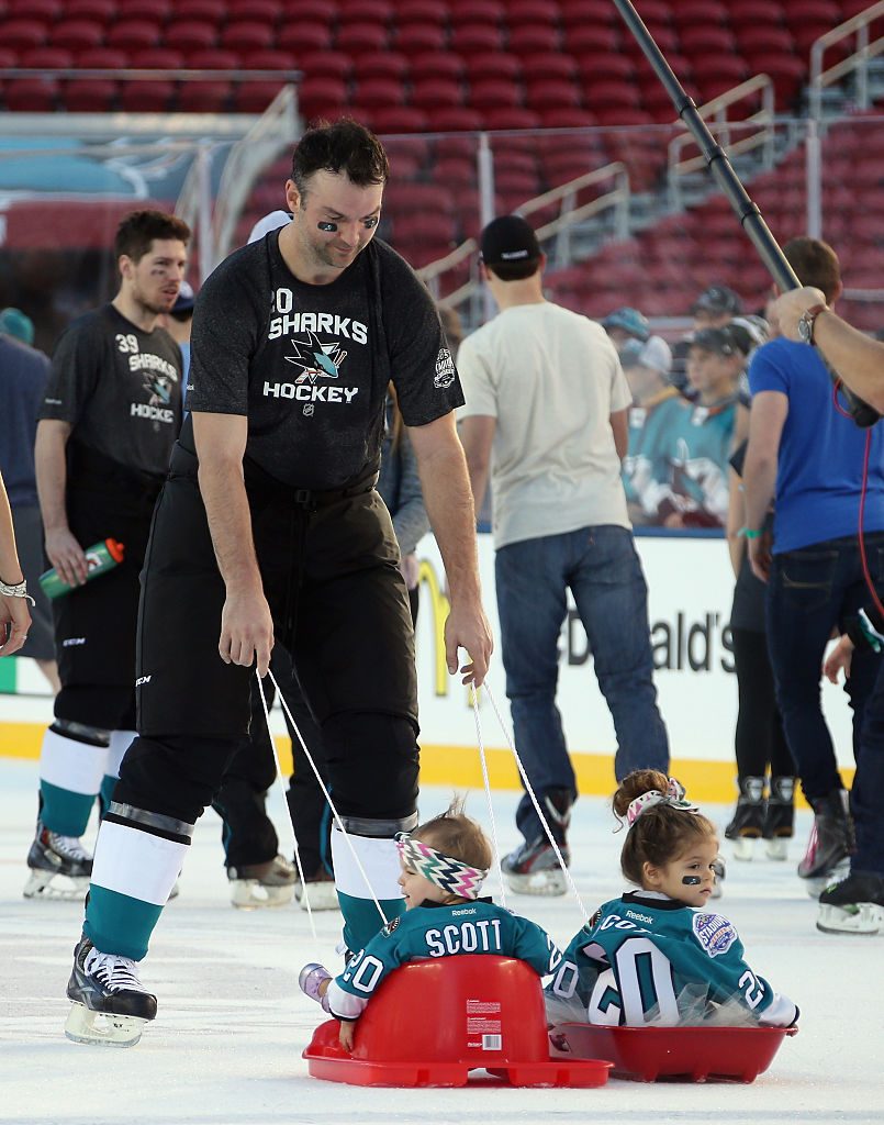 SANTA CLARA, CA - FEBRUARY 20: John Scott #20 of the San Jose Sharks takes part in the family skate with his children at Levi's Stadium on February 20, 2015 in Santa Clara, California. The practice day was held the day prior to the 2015 Coors Light NHL Stadium Series game between Anaheim and Los Angeles. (Photo by Bruce Bennett/Getty Images)