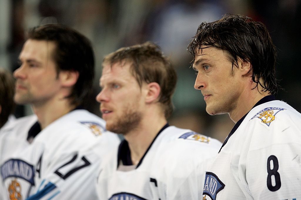 TURIN, ITALY - FEBRUARY 26: Teemu Selanne #8 of Finland, Saku Koivu #11 of Finland and Teppo Numminen #27 of Finland look dejected after Finland lost 3-2 to Sweden and took the silver medal during the final of the men's ice hockey match between Finland and Sweden during Day 16 of the Turin 2006 Winter Olympic Games on February 26, 2006 at the Palasport Olimpico in Turin, Italy. (Photo by Elsa/Getty Images)
